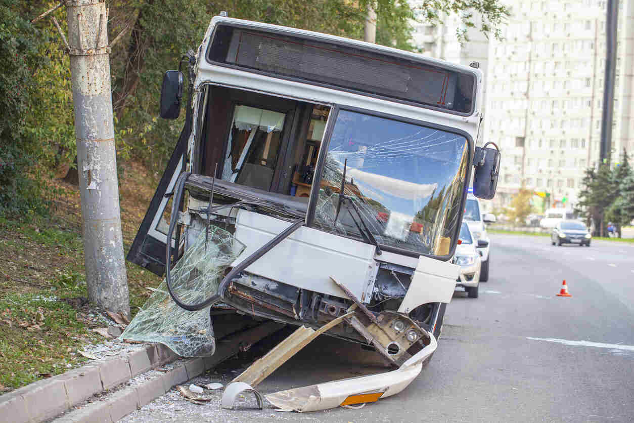 Damaged white bus with shattered windshield, symbolizing a bus accident in Salt Lake City.