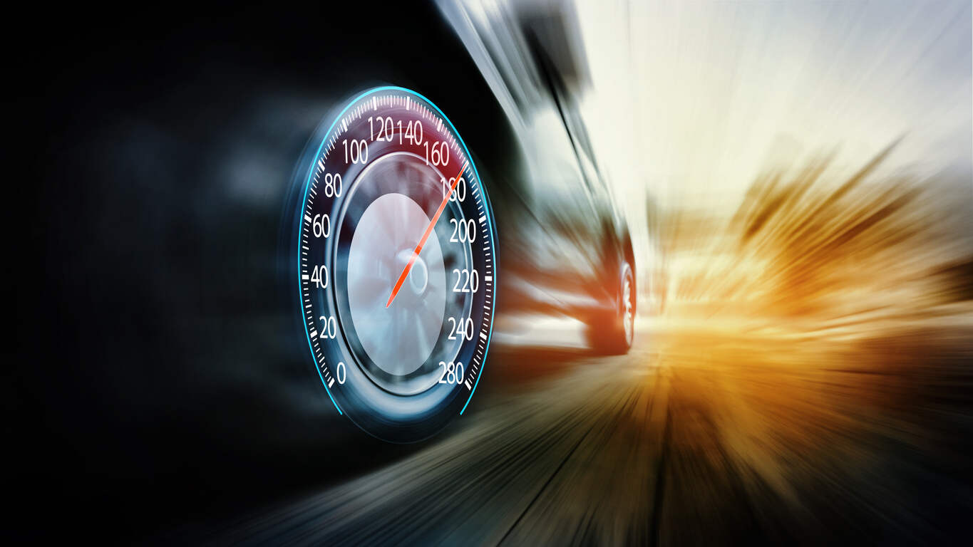 Digital speedometer indicating dangerous speed with a blurred vehicle background, relevant to speeding accident legal cases.