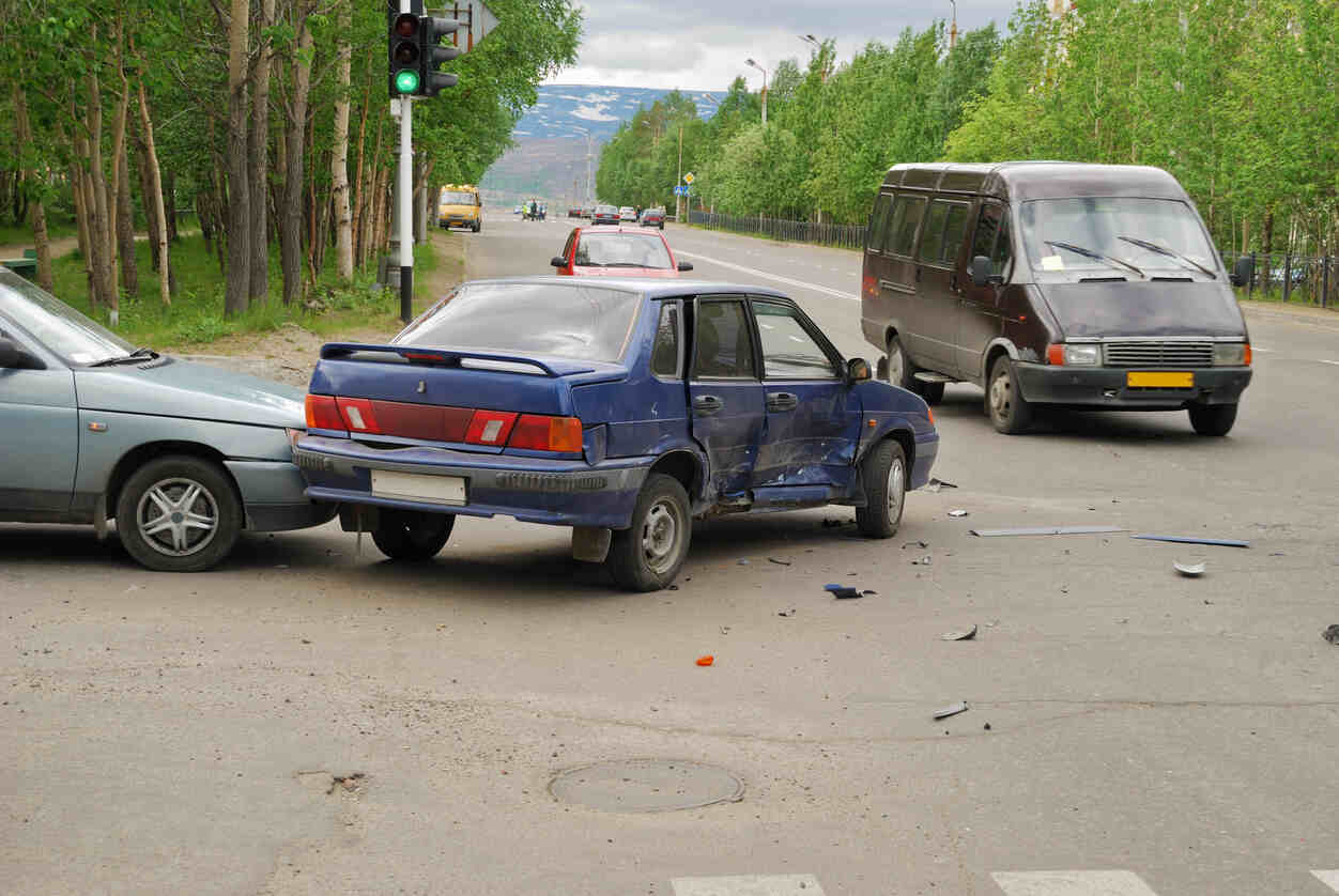 A car and a silver car are involved in a collision on a road, illustrating a multi-vehicle accident scenario with potential liability issues in Utah.